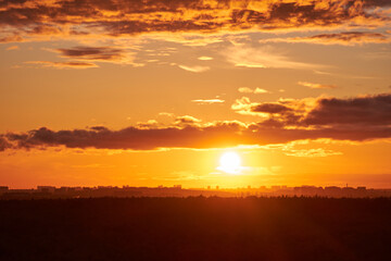 Fototapeta na wymiar Evening sky with setting sun through clouds at sunset, cloudy landscape