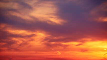Evening sky with setting sun through clouds at sunset, cloudy landscape