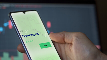 Invest in hydrogen etf fund. A phone shows the ETF's prices low carbon enegy to invest