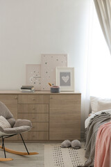 Modern chest of drawers in beautiful bedroom. Interior design