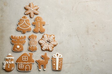 Christmas tree shape made of delicious gingerbread cookies on light table, flat lay. Space for text