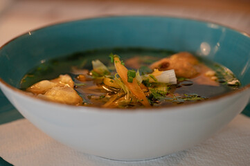 Duck broth - blue bowl and fatty, clear soup with vegetables