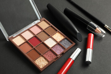 Set of makeup products on dark background