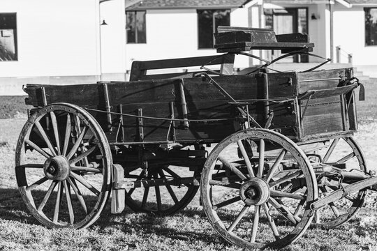 This is a digitally enhanced, monochrome image of a buck board wagon from the Oregon ghost town, Shaniko.  This image feature light and shadow and rough, weathered surfaces.
