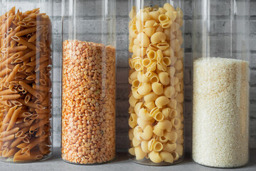 transparent glass jars with pasta, rice, peas in the kitchen, zero waste storage, kitchen pantry...