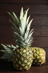 Fresh ripe juicy pineapples on wooden table