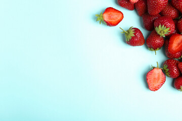 Tasty ripe strawberries on light blue background, flat lay. Space for text