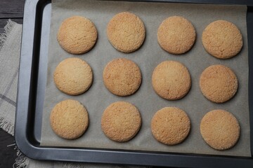 Baking sheet with delicious sugar cookies on table, top view