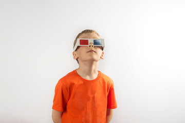 a boy in an orange T-shirt and 3 d glasses on white background.