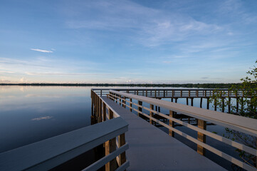 Fototapeta premium Sunrise cloudscape over West Lake boardwalk in Everglades National Park, Florida on calm summer morning.