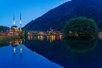 Uzungol Mosque and its reflection in water at the twilight in the mountain town of Uzungol © MehmetOZB