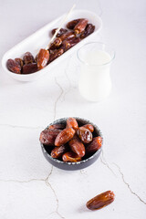 Food for the holy month of Ramadan. Dates in a bowl and milk on the table. Vertical view