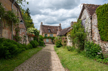 Fototapeta na wymiar One of most beautiful french villages, Gerberoy - small historical village with half-timbered houses and colorful roses flowers, France