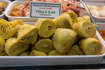 Pickled and grilled heads of fresh organic artichoke flowers, edible vegetables green artichokes,...