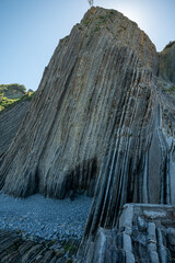 View on steeply-tilted layers of flysch on Atlantic coast at Zumaia at low tide, Basque Country,...