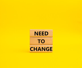 Need to change symbol. Concept words 'Need to change' on wooden blocks. Beautiful yellow background. Business and Need to change concept. Copy space.