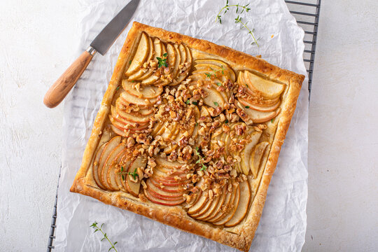 Apple tart with puff pastry tpped with walnuts and brown sugar
