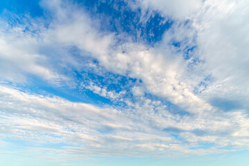 White clouds in the blue sky. Beautiful natural background.