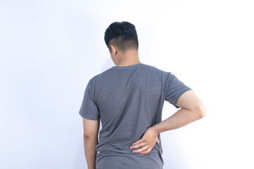 Asian men has back muscle pain from lifting heavy objects to health problems