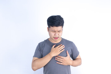 Asian man has chest pain from heart disease and coronary artery disease, health problems.
