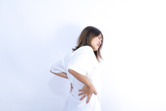 Asian woman has back muscle pain from lifting heavy objects to health problems