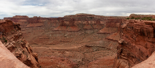 Naklejka na ściany i meble Scenic American Landscape and Red Rock Mountains in Desert Canyon. Spring Season. Canyonlands National Park. Utah, United States. Nature Background Panorama