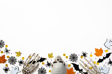 Happy Halloween holiday concept. Halloween frame border with bats, spiders, ghosts, skull, skeleton arms. Creepy Halloween flat lay.