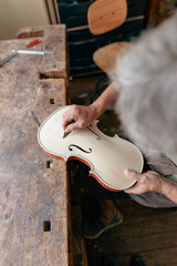 luthier carving and sculpting the f holes a violin with a knife