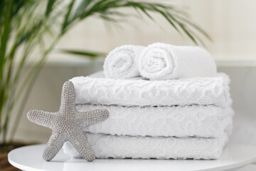 Obraz na płótnie Canvas Rolled white towels in the bathroom or a spa salon, close up