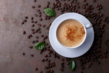 Cup of coffee cappuccino and coffee beans on the brown stone background