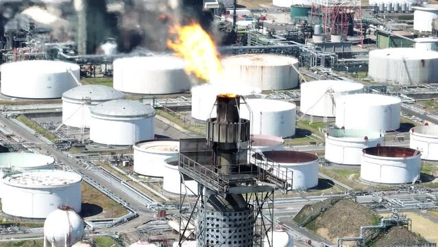 Flaring is the combustion of the gases released during petroleum production and oil refining in the harbour of Antwerpen. Large Energy efficient industry pollution global industry. Aerial drone