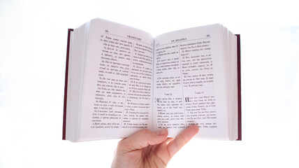 A man holds and reads the Holy Scriptures a Bible with an inscription in the Old Slavonic language. Saint Bible. gospel. New Testament.