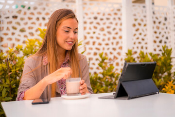 Fototapeta premium Executive woman and businesswoman having breakfast in a restaurant having a decaffeinated coffee