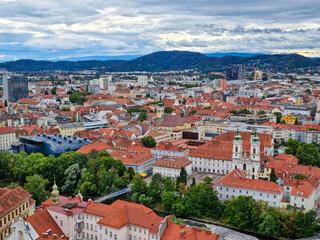 Fototapeta na wymiar Beautiful view over the old city center of Graz, with Mariahilfer church and historic buildings, in Styria region, Austria