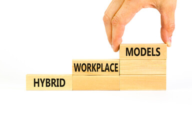 Hybrid workplace models symbol. Concept words Hybrid workplace models on wooden blocks. Businessman...