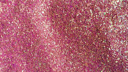 Fondo de brillos / glitter de color rojo, fucsia, rosa, dorado. Se puede usar como fondo	