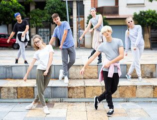 Portrait of group of teenagers at city street. Hip hop dancers