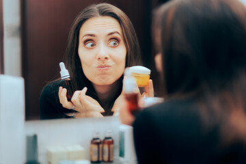 Woman Choosing Between Face Serum and Moisturizing Cream. Lady trying to find the best skin care routine for her complexion  
 - obrazy, fototapety, plakaty
