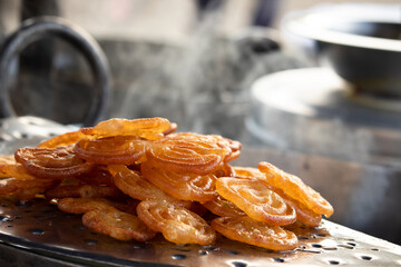 Fresh Cooked Hot Rasdar Jalebi Also Known As Jilapi, Jilebi, Jilipi, Zulbia, Jerry, Zalebi, Mushabak Mithai Made From Fermented Maida And Besan Dunked In Sugar Syrup Cheeni Ki Chasni Or Paag © Rangeecha