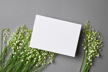 Invitation or greeting card mockup with lily of the valley flowers