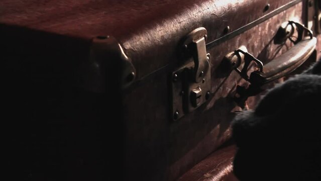 Thief tries to open the suitcase with a keylock-picking, wearing gloves to avoid leaving fingerprints