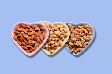 almond hazelnut and cashew nut on heart shaped plate together
