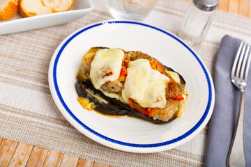 Tasty aubergine baked with ground meat, cheese, tomato and onion