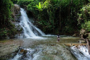 A vacation to a waterfall in the middle of the forest in the high valley.