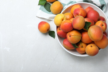 Fototapeta na wymiar Delicious fresh ripe apricots on white table, flat lay. Space for text