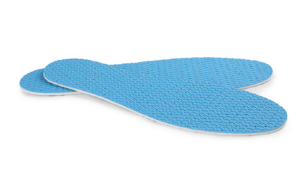 Pair of light blue insoles on white background