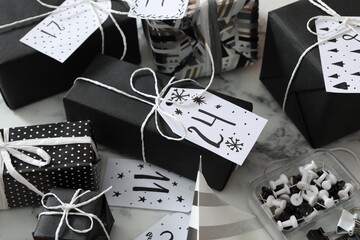 Set of gift boxes and pins on white marble table. Creating advent calendar