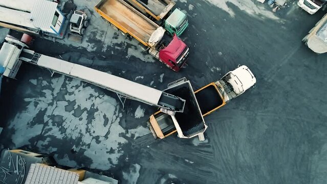 Aerial top down view of loading stone on a dump truck in a stone quarry.
