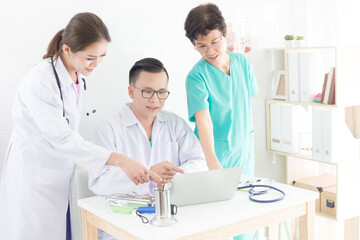 Asian doctor talk with healthcare worker team about patient information, teamwork in hospital