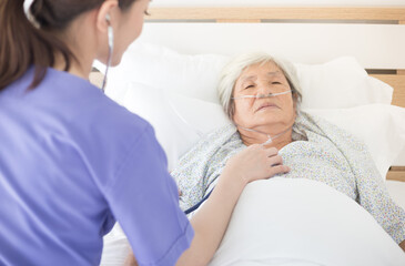 nurse screening vital sign of old asian patient , elderly health check up , palliative care